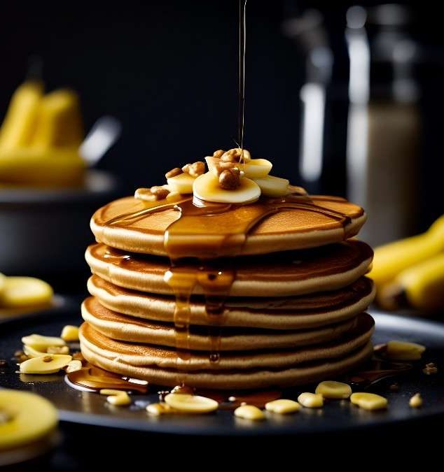 Fluffy pancakes with syrup, bananas and nuts